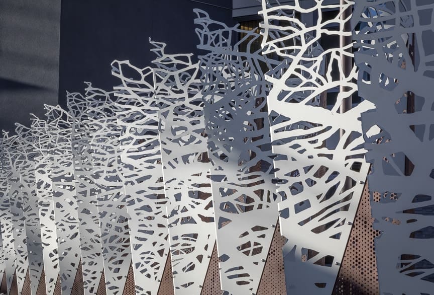 The aluminum and steel panels are alternately folded to provide depth and an intricate profile.