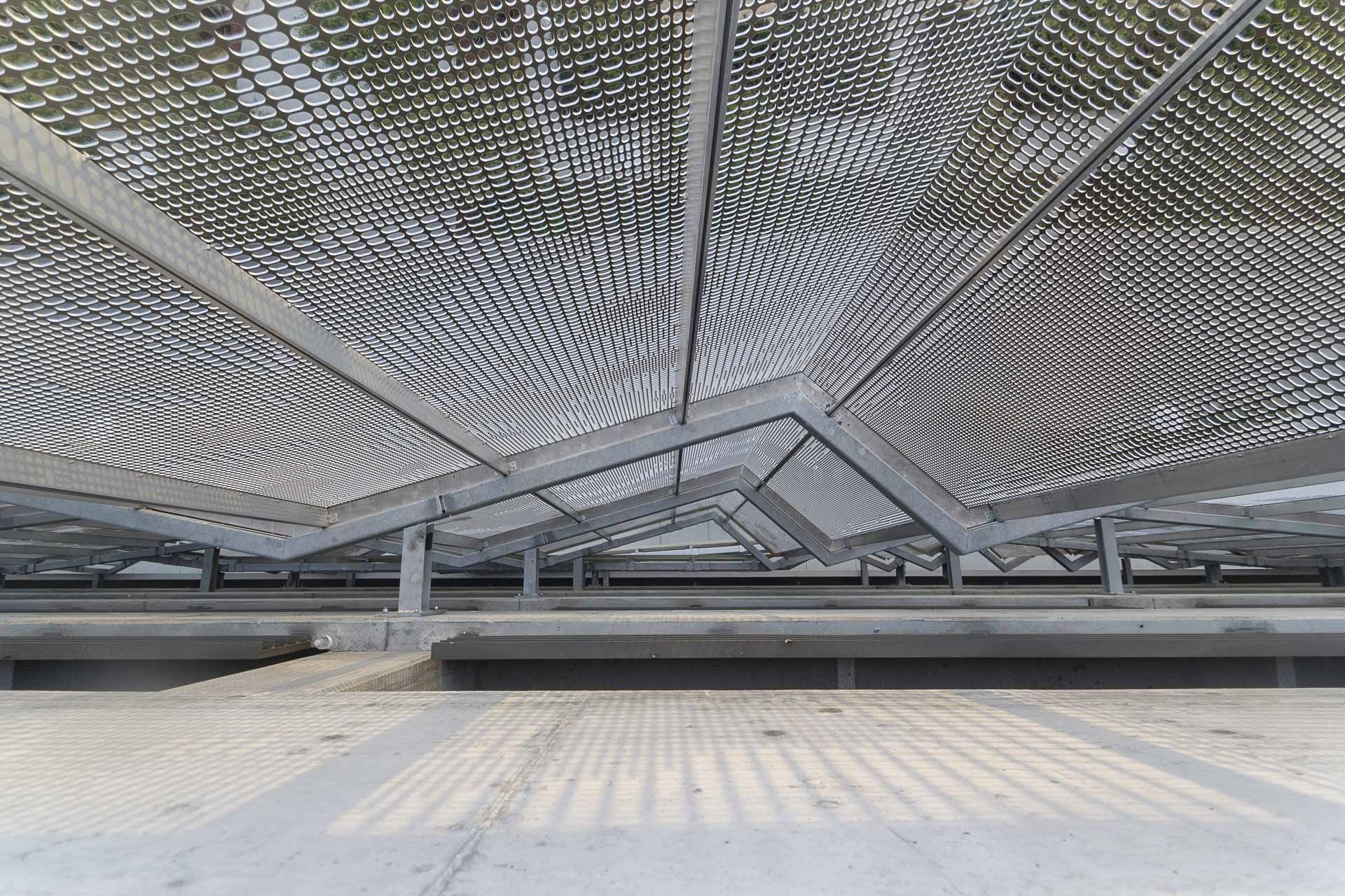 Detail of the undulating facade design by WRNS Studio with custom oval perforation design.