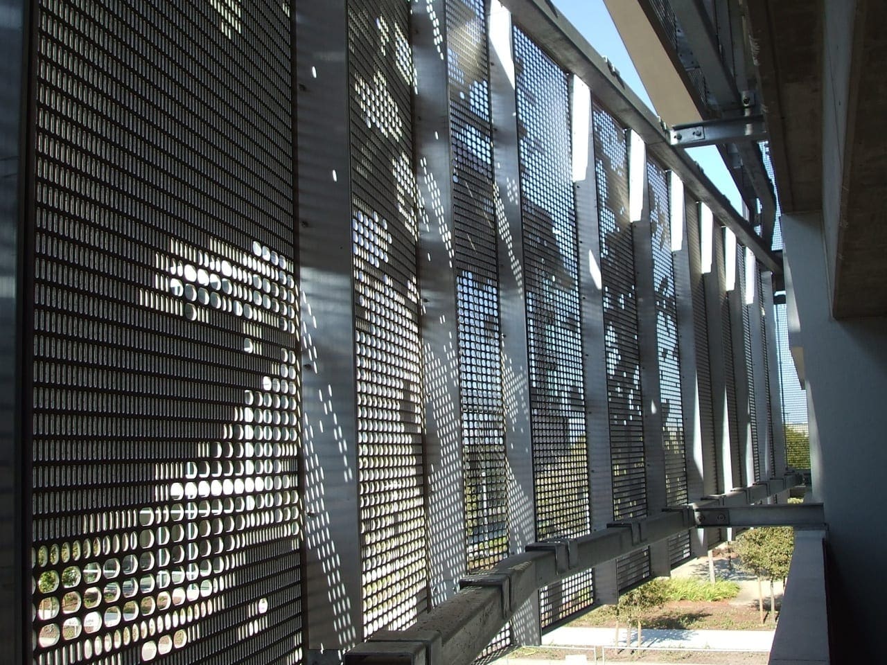 Detail of the perforated aluminum facade system from within the garage.