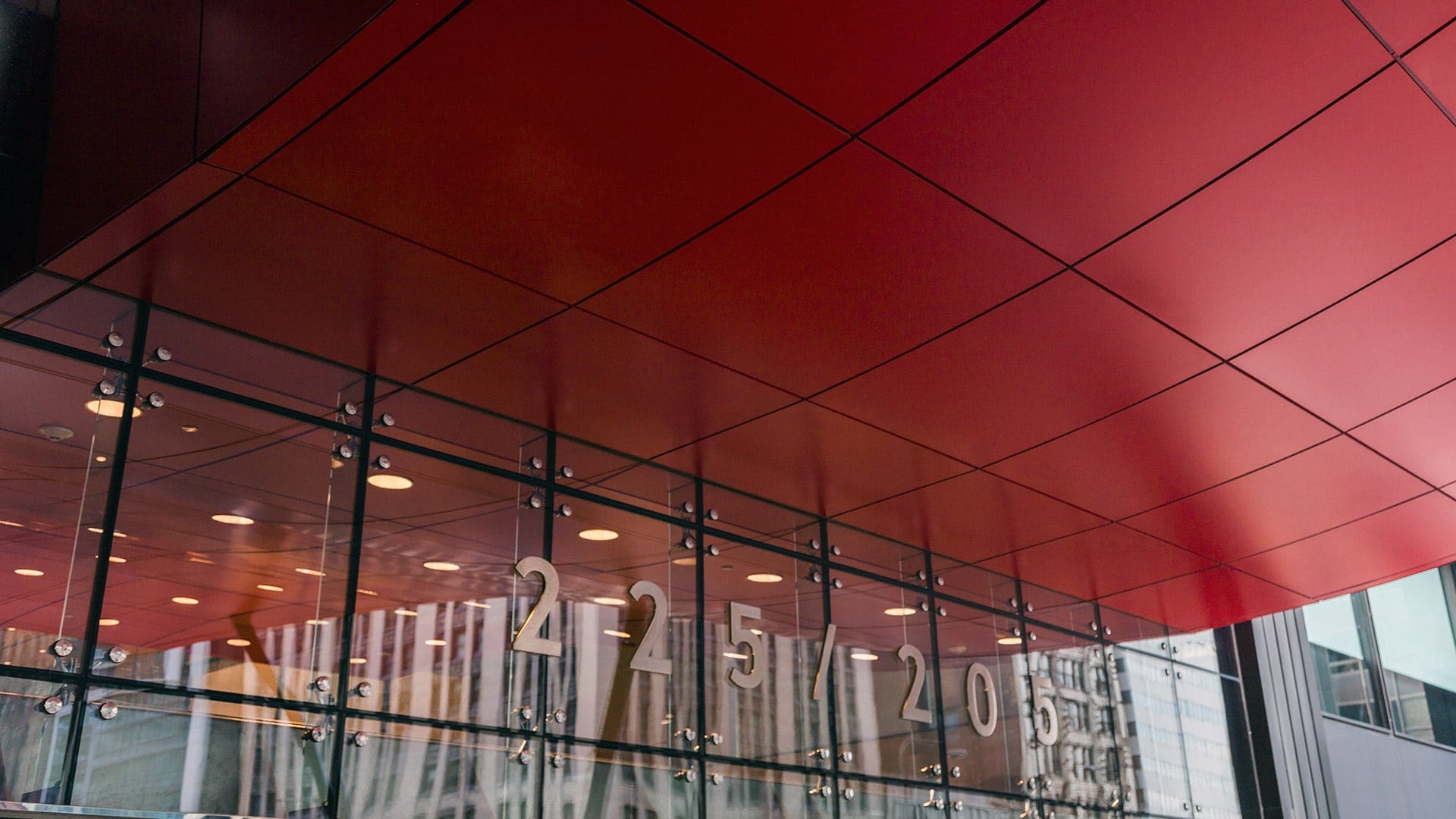 The canopy continues into the building's interior lobby, where an interior lighting system was integrated.