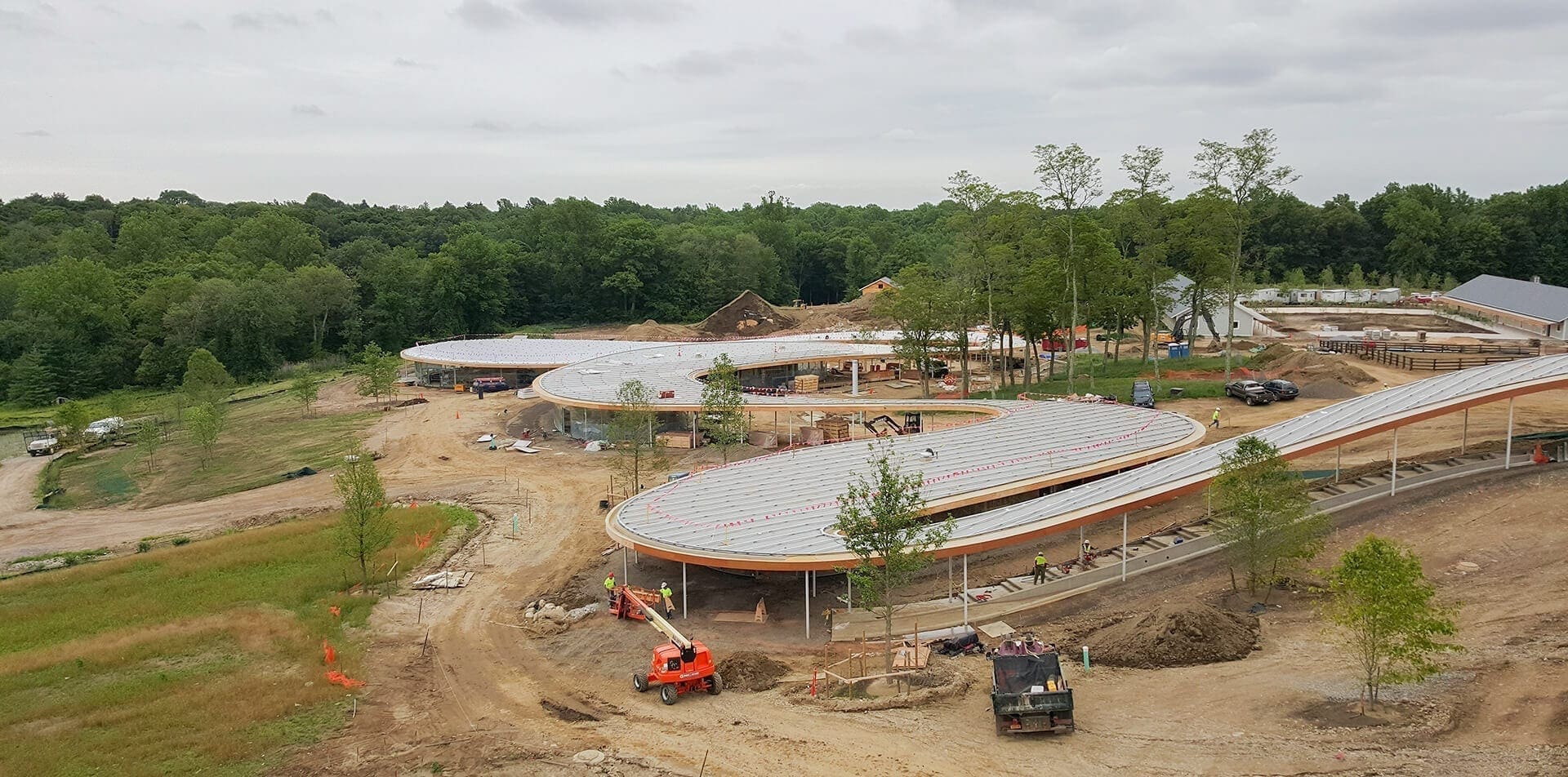 Installers lay the panels to create the dual curve roof on Grace Farms.