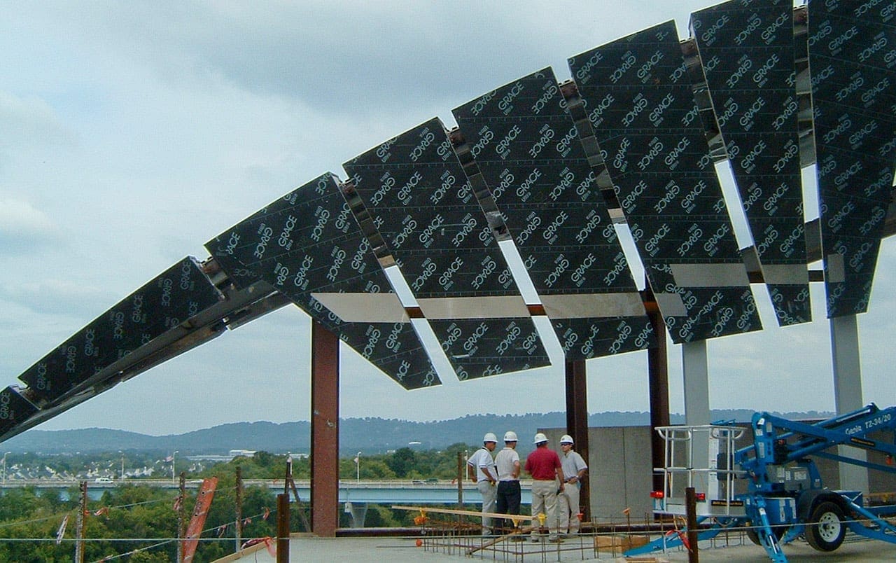 Contractors standing below several recently installed ZEPPS® Panels during construction.