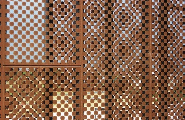 Moire patterns from overlapping perforated metal.