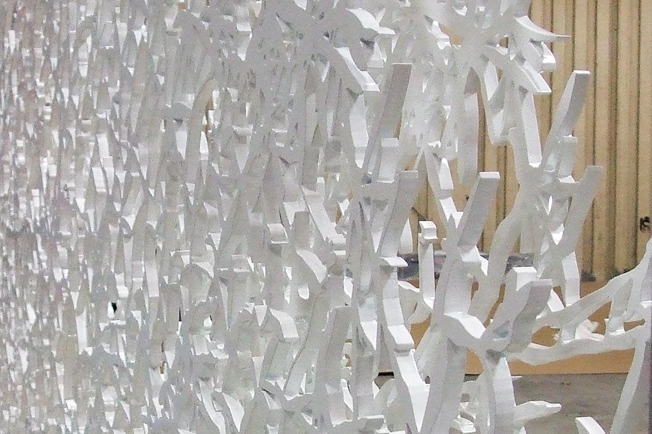 Side detail shows the dramatic thickness of the aluminum plates.