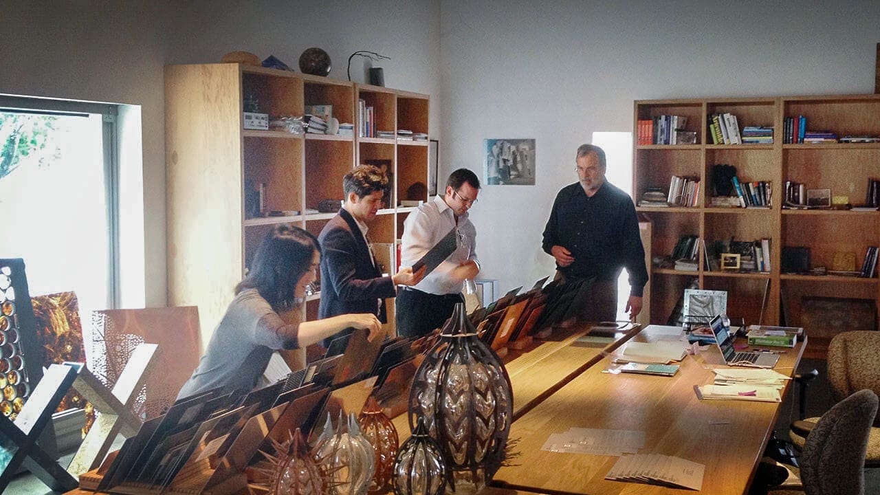From left: Lisa Iwamoto, Chris Leong, Brad Giresi, Bill Zahner, look at material samples in the Zahner library.