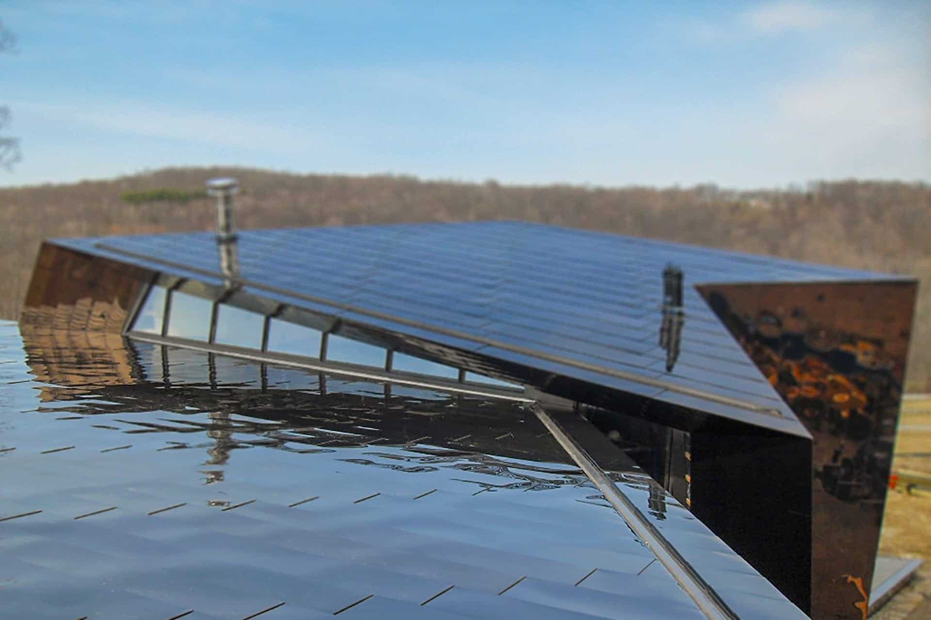 The metal skin wraps the roof of the residence.