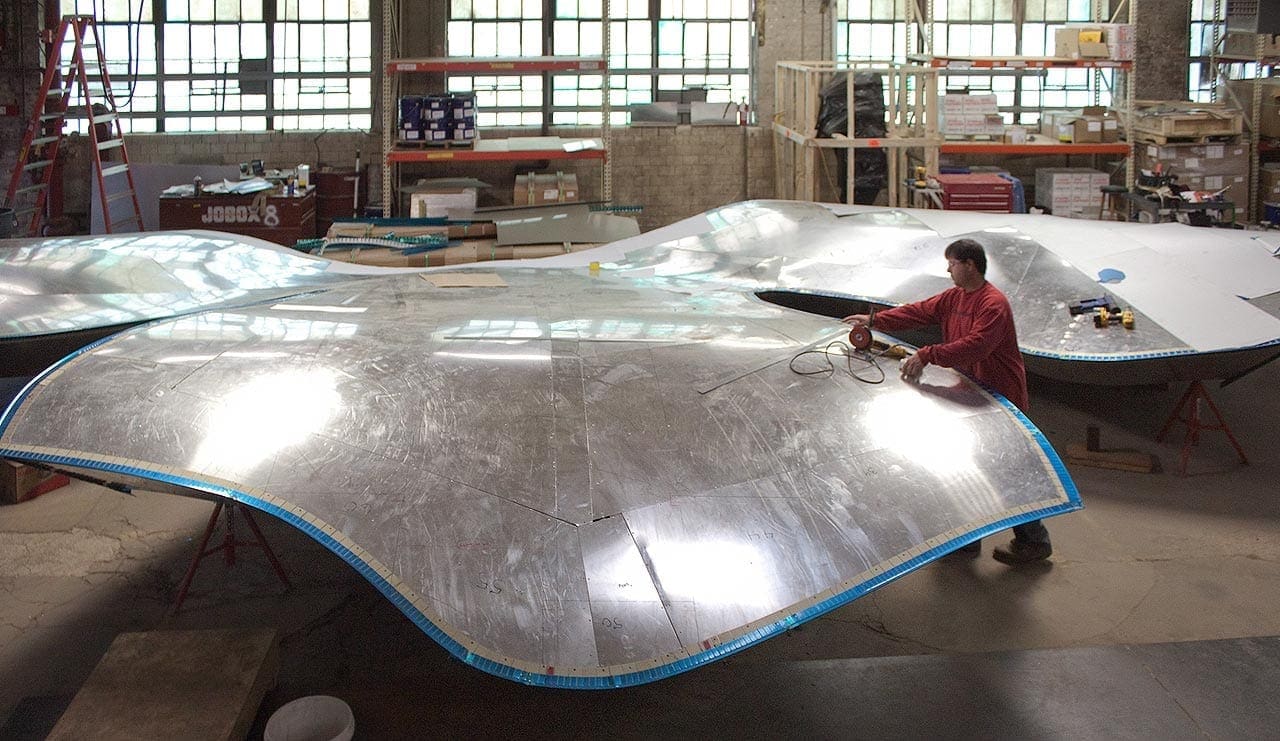 Fabricator in the Zahner shop grinds aligns ZEPPS® Panels.