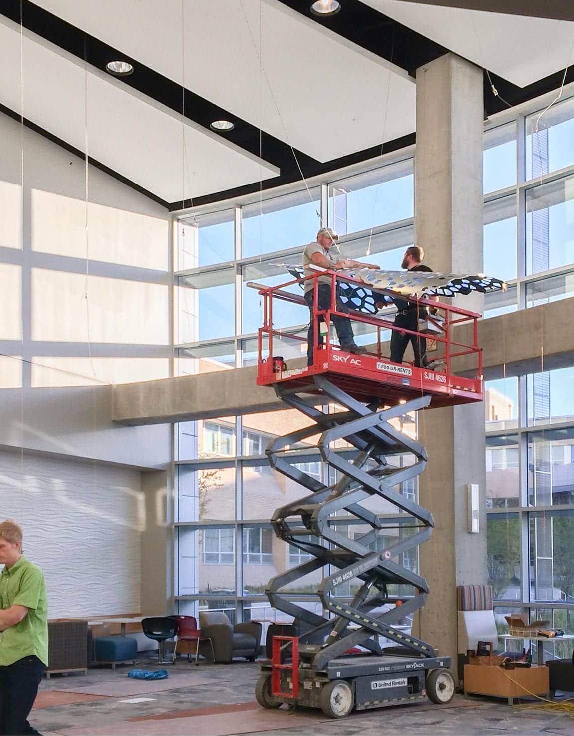 Zahner installers hang the panels using the cable system.