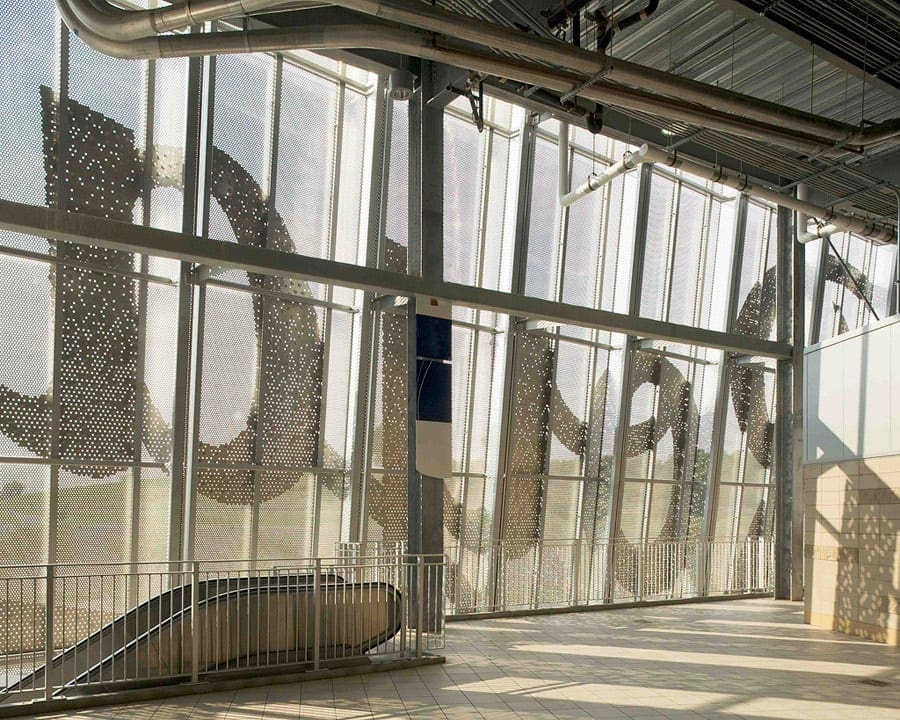 Light flows into through the perforated facade.