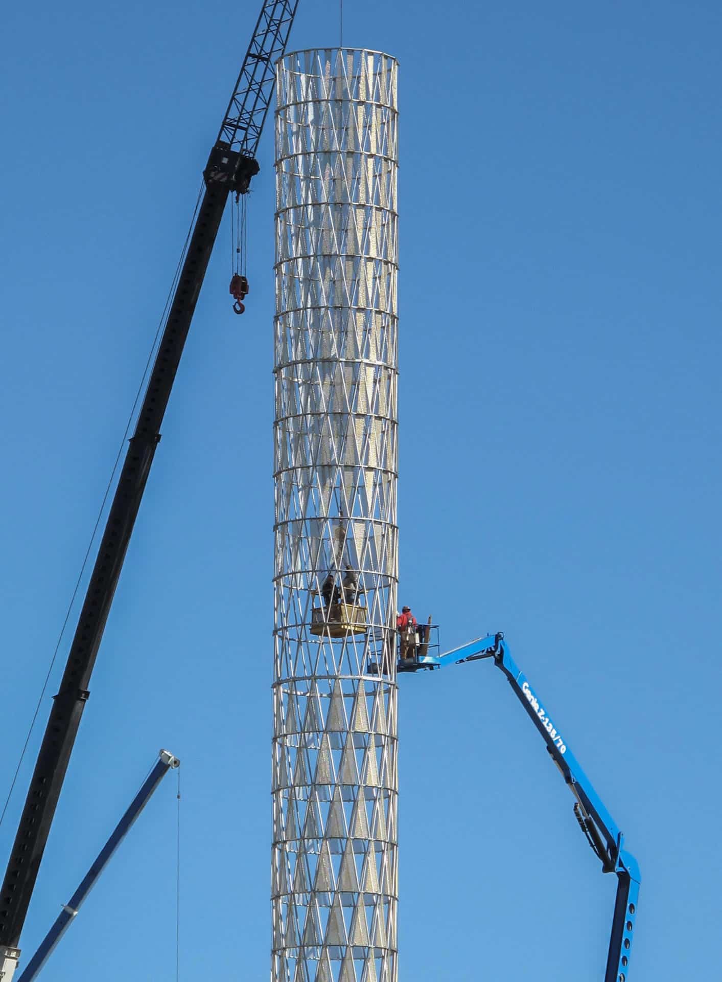 Installers place the triangular curving panels at UNMC in Nebraska.