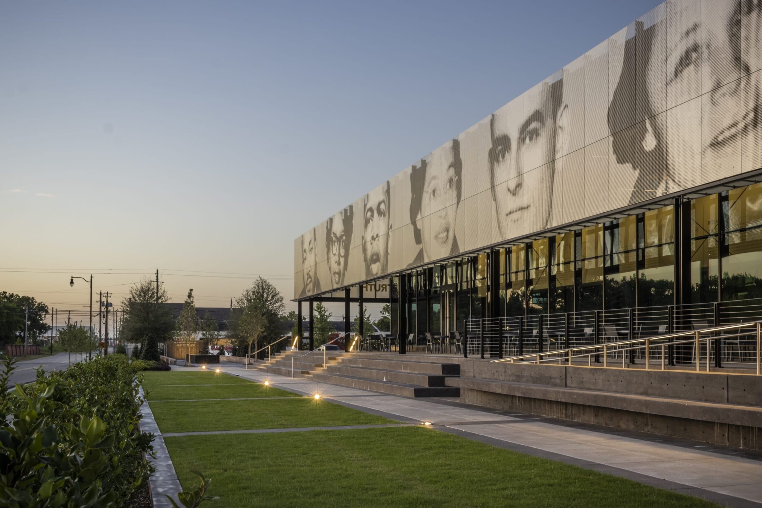 The iconic figures depicted on the EJI Legacy Pavilion ImageWall include Martin Luther King Jr., Claudette Colvin, John Lewis, Rosa Parks, Jonathan Daniels, Jo Ann Robinson, and E.D.
