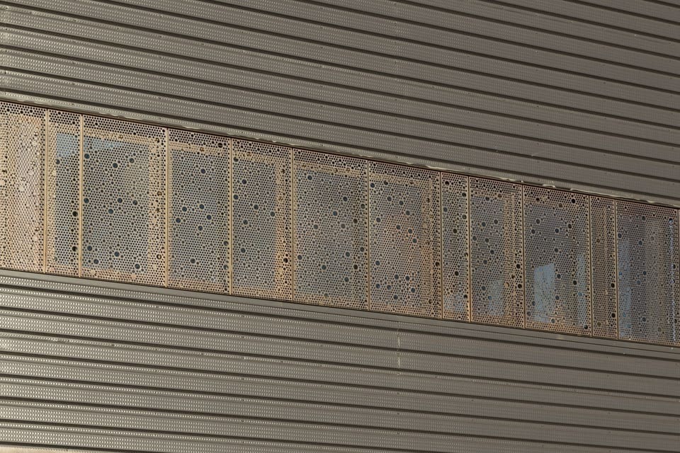 CUSTOM PERFORATED WINDOW SCREENS FOR JOHN OLVER TRANSIT CENTER.