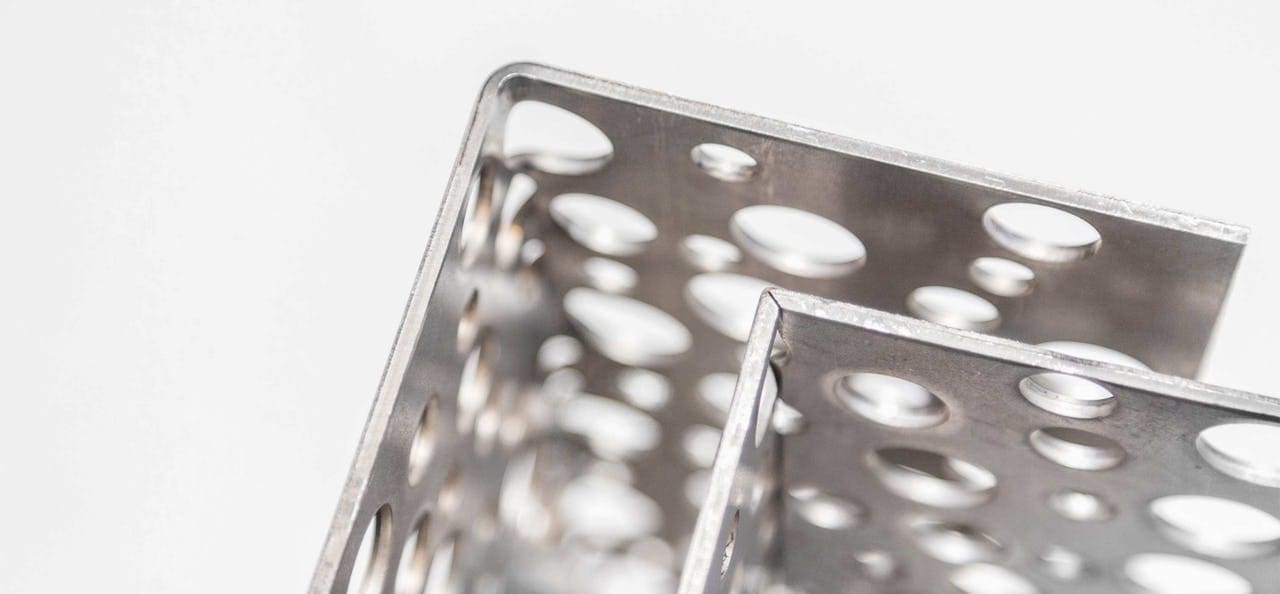 BRAKE-FORMING VS RADIUS REDUCTION: EXAMPLE OF PERFORATED METAL SHOWING V-NOTCHED VS BRAKE-FORMED EDGES.